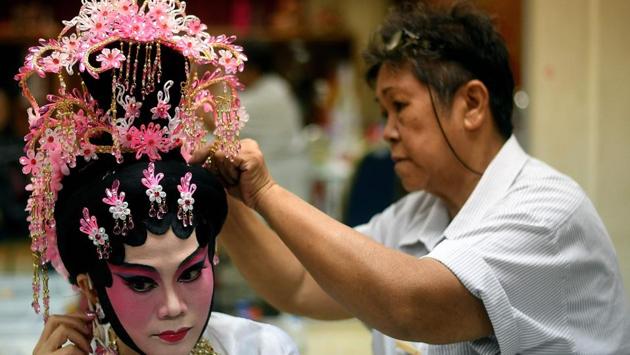 An ethnic Malaysian-Chinese Cantonese opera actress (L) from the Sound of Tai Hei group prepares backstage before an opera performance in Kuala Lumpur. (MANAN VATSYAYANA / AFP) An ethnic Malaysian-Chinese Cantonese opera actress (L) from the Sound of Tai Hei group prepares backstage before an opera performance in Kuala Lumpur. (MANAN VATSYAYANA / AFP)