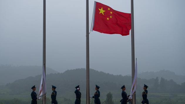The Chinese flag being raised during the opening ceremony of the International Army Games 2017 in Guangshui in China's central Hubei province.(AFP)