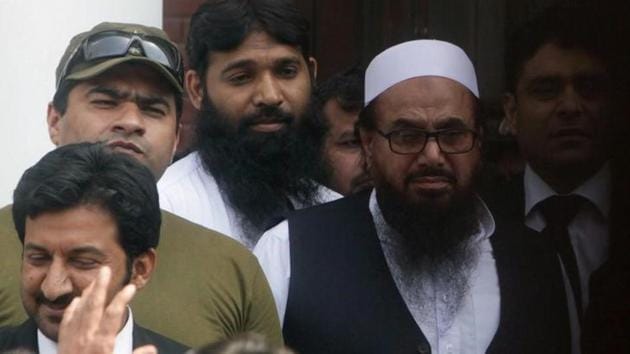 Hafiz Saeed, chief of the Jamaat-ud-Dawa (JuD), leaves after a court appearance in Lahore. (REUTERS File Photo)