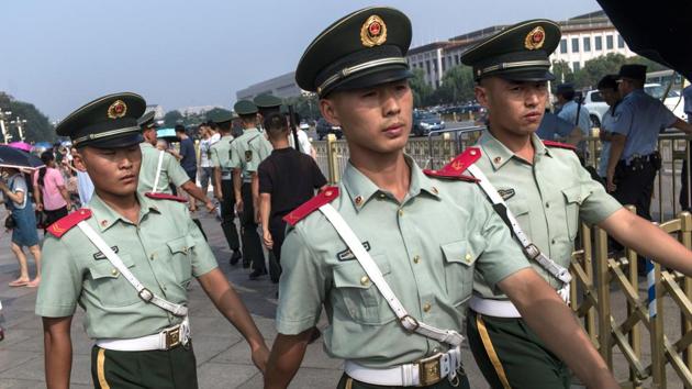 Chinese paramilitary guards walk in front of The Forbidden City in Beijing on July 31, 2017, on the eve of the 90th founding anniversary of the People's Liberation Army (PLA). (AFP) Chinese paramilitary guards walk in front of The Forbidden City in Beijing on July 31, 2017, on the eve of the 90th founding anniversary of the People's Liberation Army (PLA). (AFP)