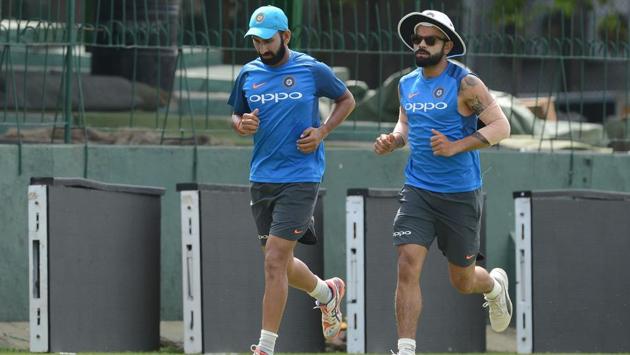 Virat Kohli and Cheteshwar Pujara warm up before a practice session at Colombo. (AFP)