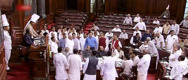 Opposition MPs storm into the Well of Rajya Sabha to protest government’s decision to hike the prices of LPG cylinder, in New Delhi on Tuesday. (PTI Photo) Opposition MPs storm into the Well of Rajya Sabha to protest government’s decision to hike the prices of LPG cylinder, in New Delhi on Tuesday. (PTI Photo)