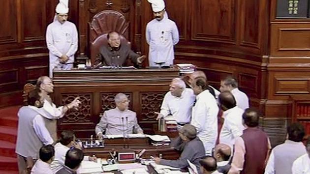Finance minister Arun Jaitley talks to the opposition members in the Well of Rajya Sabha in New Delhi on Monday during the ongoing monsoon session.(PTI Photo)