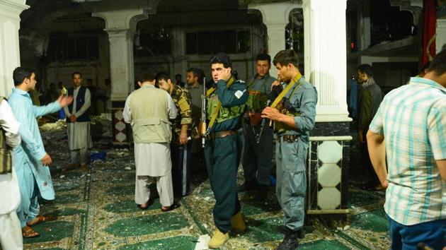 Afghan security personnel inspect the site after the suicide bomb attack at a Shiite mosque in Herat. (Hoshang Hashimi / AFP)