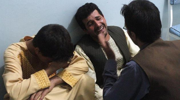 Relatives mourn after a suicide attack on a mosque in Heart. (Hamed Sarfarazi / AP)