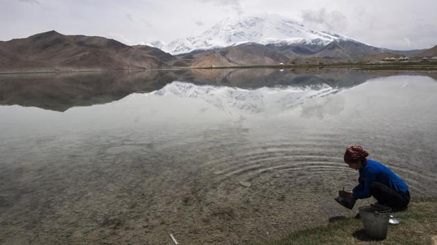 A woman collecting water from the Karakul Lake before the Karakorum mountain range next to the China-Pakistan Friendship Highway, near Tashkurgan. The remote town of around 9,000 is at the geographic heart of Beijing’s plans to build a major trade artery – the China-Pakistan Economic Corridor (CPEC) — connecting Kashgar to the Arabian Sea port of Gwadar. (Johannes EISELE / AFP) 