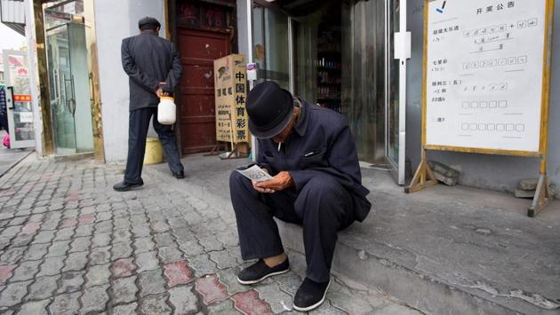 A man looking at his lottery ticket in Tashkurgan, China's western Xinjiang province.  India  has boycotted the Belt and Road Intiative, mainly due to concerns over the China-Pakistan Economic Corridor, a key part of the initiative that runs through disputed Kashmir. (Johannes EISELE / AFP) 