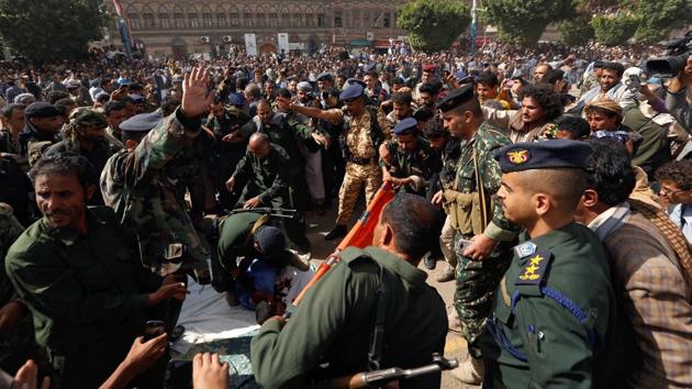 Four shots rang loud in the air, and justice was served. As the echoes spread out, the crowd rushed in towards the body but was held off by the security cordon. (Khaled Abdullah / REUTERS)