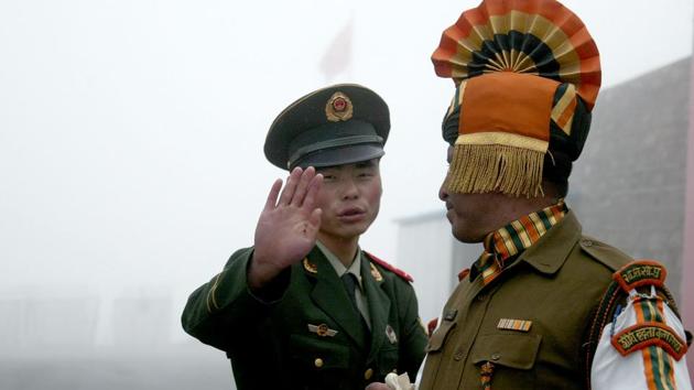 A Chinese soldier (left) next to an Indian soldier at the Nathu La border crossing between the two countries in Sikkim.(AFP File Photo)