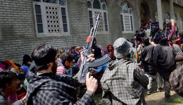 Suspected militants brandish their guns and shout slogans at the funeral of a slain colleague at Qoimoh in Kulgam district of south Kashmir. (PTI File Photo) Suspected militants brandish their guns and shout slogans at the funeral of a slain colleague at Qoimoh in Kulgam district of south Kashmir. (PTI File Photo)