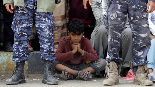 Hundreds of onlookers gathered at the site to witness the public shooting, the country’s first in nearly a decade, with many perched on telephone poles and rooftops amid a tight security cordon. Authorities feared retributive violence from members of the Bani Matar tribe to which the aggrieved family belongs. (Khaled Abdullah / REUTERS)
