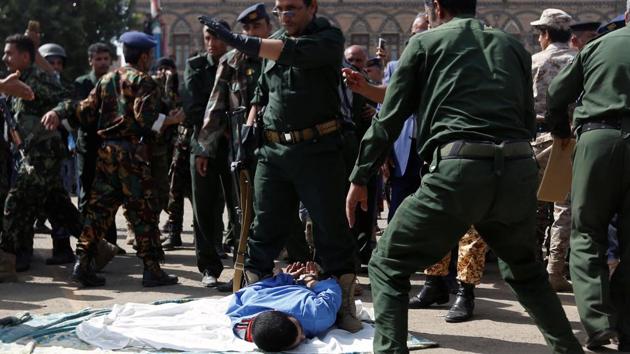 In the moments leading to the execution, the crowds broke into chants of ‘Allah is the greatest’, while the convicted man tried speaking to his executioner who stood by him smoking a cigarette, before taking aim with his AK-47. (Khaled Abdullah / REUTERS)