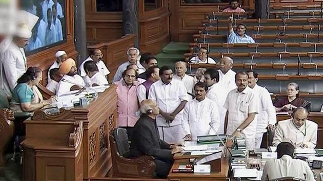 Members protest in the well of the Lok Sabha in New Delhi on Wednesday. (PTI Photo) Members protest in the well of the Lok Sabha in New Delhi on Wednesday. (PTI Photo)