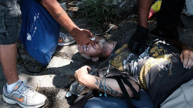 A man administers Naloxone as they try to revive a man who overdosed on heroin. The interim report recommends the prescription of naloxone, a fast-acting overdose reversal drug along with high-risk opioids and its inclusion in the arsenal of law enforcement officers across the country. (Spencer Platt / Getty Images / AFP) A man administers Naloxone as they try to revive a man who overdosed on heroin. The interim report recommends the prescription of naloxone, a fast-acting overdose reversal drug along with high-risk opioids and its inclusion in the arsenal of law enforcement officers across the country. (Spencer Platt / Getty Images / AFP)