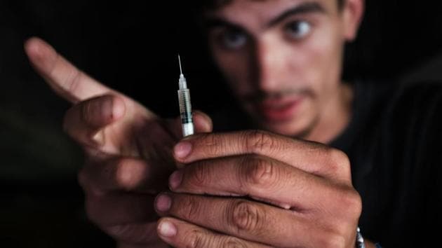 Mike, 22, a heroin addict who began using opiates when he was 13, pauses to shoot-up by a railway underpass in the Kensington section of Philadelphia which has become a hub for heroin. Hundreds of outreach workers, city employees and Conrail workers started to clear an area known as El Campamento. Over 900 people died last year in Philadelphia from opioid overdoses, a 30 percent increase from 2015. (Spencer Platt / Getty Images / AFP) Mike, 22, a heroin addict who began using opiates when he was 13, pauses to shoot-up by a railway underpass in the Kensington section of Philadelphia which has become a hub for heroin. Hundreds of outreach workers, city employees and Conrail workers started to clear an area known as El Campamento. Over 900 people died last year in Philadelphia from opioid overdoses, a 30 percent increase from 2015. (Spencer Platt / Getty Images / AFP)