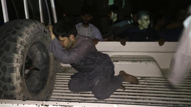 A wounded man rests on a vehicle after a suicide attack on a mosque in Heart. There was no claim of responsibility. But the Taliban, fighting to install strict Islamic law and drive foreign troops out of Afghanistan, denied any involvement. (Hamed Sarfarazi / AP)