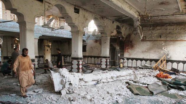 Relatives of the dead inspect the site after an overnight suicide attack at a mosque in Herat, Afghanistan. (Reuters photo) Relatives of the dead inspect the site after an overnight suicide attack at a mosque in Herat, Afghanistan. (Reuters photo)