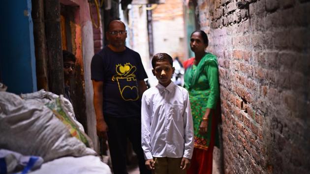 Sonu with his parents outside his house in east Delhi’s New Seemapuri. He started going to a formal school on July 10 this year. (Arun Sharma/HT Photo) Sonu with his parents outside his house in east Delhi’s New Seemapuri. He started going to a formal school on July 10 this year. (Arun Sharma/HT Photo)