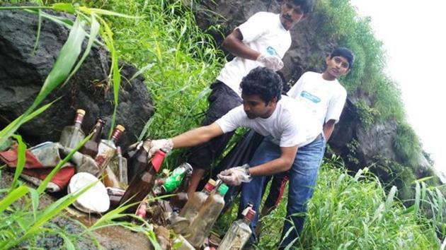 Members of NGO Environment Life cleared alcohol bottles from Bhivpuri waterfall earlier this month. (HT File Photo) Members of NGO Environment Life cleared alcohol bottles from Bhivpuri waterfall earlier this month. (HT File Photo)