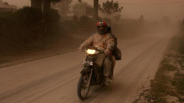 A motorist rides his motorbike following an eruption of Mount Sinabung volcano. (YT Haryono / REUTERS)
