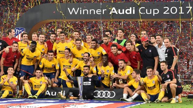 Atletico Madrid team pose with the trophy during the winners’ ceremony after the final of the Audi Cup against Liverpool FC at the Allianz Arena in Munich on Wednesday.(AFP)