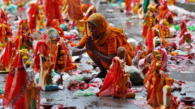 A devotee offers prayers to an idol, a day after Dashama festival ahead of its immersion in Ahmedabad, Gujarat. The festival was observed from July 24th and culminated on August 02nd this year. During this period mostly women members of the family bring home a statue of the goddess and offer it wheat and betel nut. The person who brings in the statue then undergoes a ten day partial fast, living on a wheat based diet and one meal a day. (Amit Dave / REUTERS)