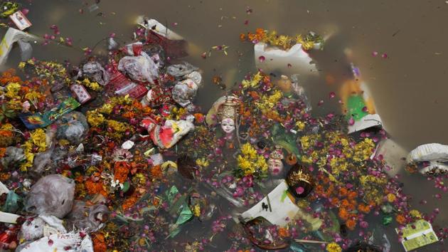 Idols of Hindu goddess Dashama float among flowers, fruit and material offerings along with plastic waste in the waters of the Sabarmati in Ahmedabad, India. The practice of immersing idols into water bodies is observed across India during a number of festivals. The impact on the water bodies’ health however stems from inadequate attention to clean-up measures and the impact of waste and dyes on ecology. (Ajit Solanki / AP)