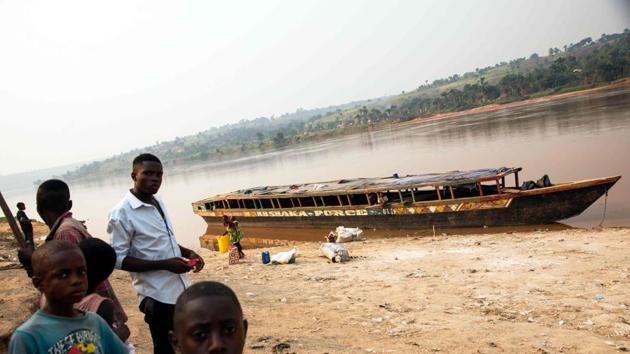 People standing next to an empty boat as the traffic on the Kasai river has been slowed down due to insecurity at the port of Tshikapa, Democratic Republic of Congo. (AFP photo) People standing next to an empty boat as the traffic on the Kasai river has been slowed down due to insecurity at the port of Tshikapa, Democratic Republic of Congo. (AFP photo)