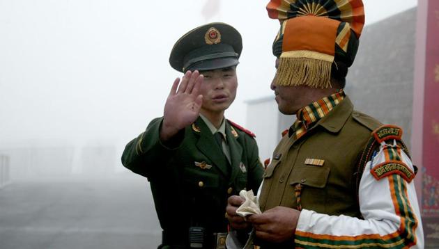 A Chinese soldier and an Indian soldier at the Nathu La border crossing between India and China in Sikkim. A border standoff has heightened tension between the two neighbours.(AFP File Photo / Representational)