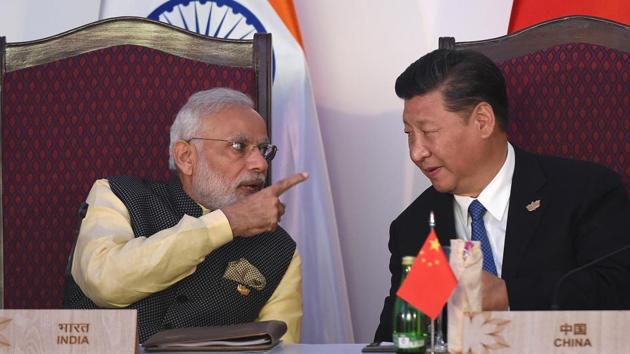 Indiam Prime Minister Narendra Modi (l) gestures while talking to China’s President Xi Jinping during a BRICS meeting in Goa laat year.(AFP file photo)