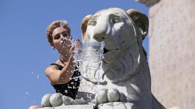 A woman cools off in a fountain at Piazza del Popolo in Rome, Italy on Thursday. (AP photo) A woman cools off in a fountain at Piazza del Popolo in Rome, Italy on Thursday. (AP photo)