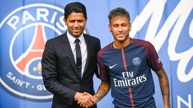 Neymar (R) shakes hands with Paris Saint Germain's president Nasser Al-Khelaifi during his unveiling at the Parc des Princes. (AFP)