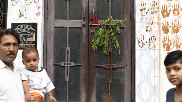 Terrorised by mysterious chopping of hair over the oast month, people have resorted to putting lemon-chillies, neem leaves and hand imprints at the entrance of their house.(Saumya Khandelwal/HT PHOTO)