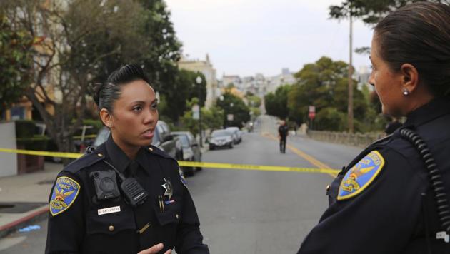 San Francisco police officer Grace Gatpandan speaks with another officer as they respond to reports of a shooting at Dolores Park in San Francisco. (AP) San Francisco police officer Grace Gatpandan speaks with another officer as they respond to reports of a shooting at Dolores Park in San Francisco. (AP)