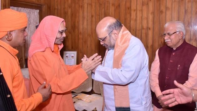 BJP national president Amit Shah greeting BJP MP from Alwar Mahant Chand Nath at the Baba Mastnath Math in Rohtak on Friday. (HT Photo) BJP national president Amit Shah greeting BJP MP from Alwar Mahant Chand Nath at the Baba Mastnath Math in Rohtak on Friday. (HT Photo)