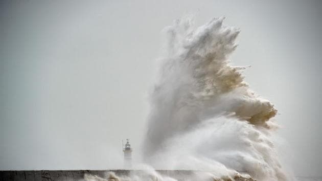 This file photo taken on February 8, 2016 shows waves crashing over Newhaven Lighthouse on the south coast of England. Deaths due to weather-related disasters in Europe could increase fifty-fold from an estimated 3,000 per year recently to 152,000 by century's end, mainly due to climate change, researchers warned. (AFP Photo)