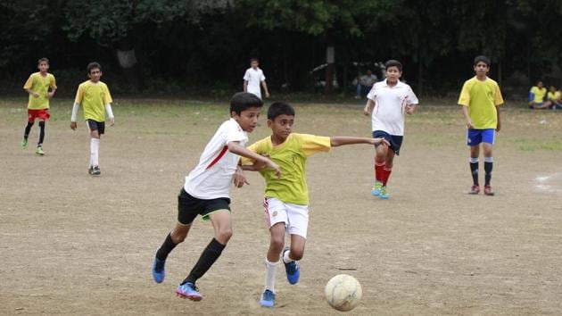 Players of Millennium National school, (yellow) & Vikhe Patil Memorial School (white) in action during the football match at SSPM college ground in Pune on Friday. (Rahul Raut/HT PHOTO) Players of Millennium National school, (yellow) & Vikhe Patil Memorial School (white) in action during the football match at SSPM college ground in Pune on Friday. (Rahul Raut/HT PHOTO)