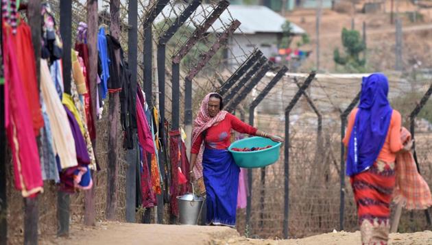 A woman carries her laundry past washing hanging up to dry on the India-Myanmar border fencing at Moreh, some 120 kms from Imphal, the capital city of Manipur on March 10, 2017. India and Myanmar share a 1,624-kilometer (1,009 miles)-long border. Border fencing is still not completed in India-Myanmar border. (AFP Representative Photo)