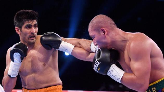 Vijender Singh in action against Chinese boxer Zulpilkar Maimaitiali during their 'Battleground Asia' main event.(PTI) Vijender Singh in action against Chinese boxer Zulpilkar Maimaitiali during their 'Battleground Asia' main event.(PTI)