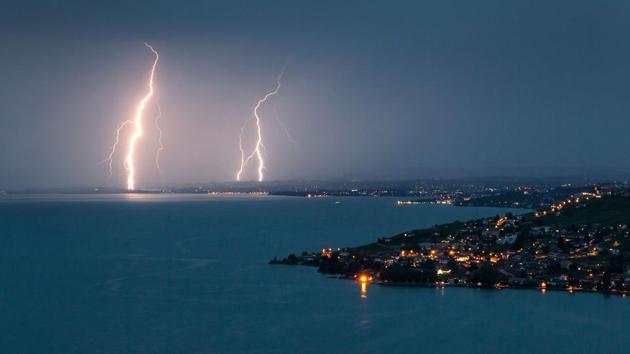 Lightning illuminates the night sky over the village of Cully surrounded by the vineyard terraces of Lavaux on the bank of Leman Lake from Chexbre. (Fabrice COFFRINI / AFP)