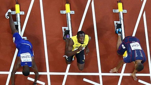 Usain Bolt gets ready at the starting blocks before the men's 100 metres final of the IAAF World Championships of Athletics in London on Saturday (Getty Images)