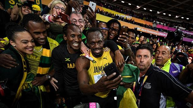 An Usain Bolt lap of honour is incomplete without a selfie with friends/family and Jamaican fans and on Saturday, after his final career 100m solo race, Bolt obliged a few. (Getty Images)