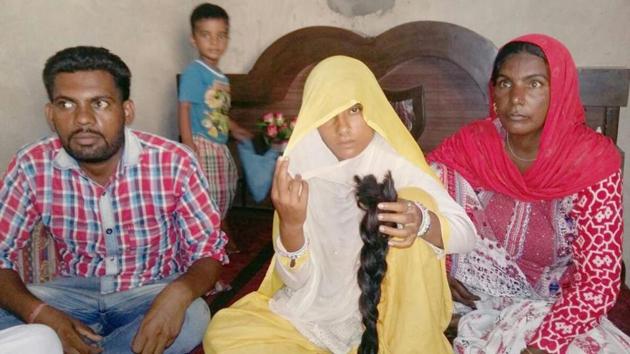 Meena Devi of Chandu village in Sangrur showing the braid that she claimed was chopped in sleep on Friday night. (HT Photo) Meena Devi of Chandu village in Sangrur showing the braid that she claimed was chopped in sleep on Friday night. (HT Photo)