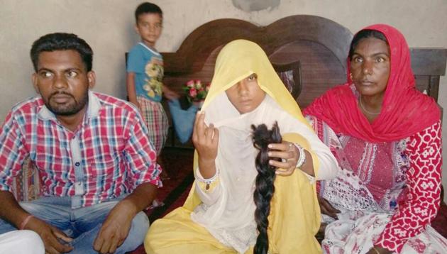 Meena Devi of Chandu village in Sangrur showing the braid that she claimed was chopped in sleep on Friday night. (HT Photo) Meena Devi of Chandu village in Sangrur showing the braid that she claimed was chopped in sleep on Friday night. (HT Photo)