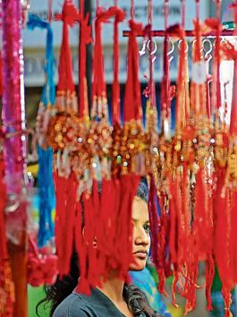 A woman does some last-minute rakhi shopping at a roadside stall in Parel on Sunday. (Satyabrata Tripathy/HT) A woman does some last-minute rakhi shopping at a roadside stall in Parel on Sunday. (Satyabrata Tripathy/HT)