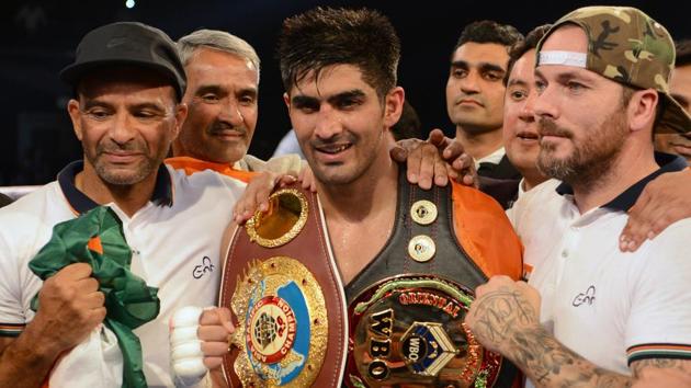 Vijender Singh poses with trainer Lee Beard (R) after beating China's Zulpikar Maimaitiali to add the WBO Oriental Super Middleweight to his WBO Asia Pacific Super Middleweight champion belt during ‘Battleground Asia’ at the National Sports Complex of India (NSCI) Dome in Mumbai on Saturday. Vijender won the 10-round encounter via unanimous decision. (AFP)