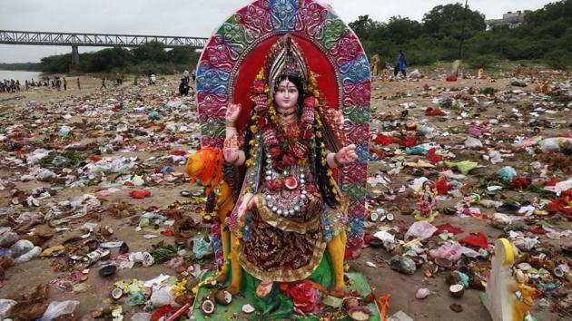 An idol of Hindu goddess Dashama stands among offerings and worship materials on the bank of river Sabarmati after the end of Dashama festival in Ahmadabad, India. (Ajit Solanki / AP) An idol of Hindu goddess Dashama stands among offerings and worship materials on the bank of river Sabarmati after the end of Dashama festival in Ahmadabad, India. (Ajit Solanki / AP)
