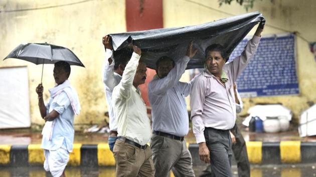 People were caught in the light rain at Jantar Mantar in New Delhi. (Sushil Kumar/HT PHOTO) People were caught in the light rain at Jantar Mantar in New Delhi. (Sushil Kumar/HT PHOTO)