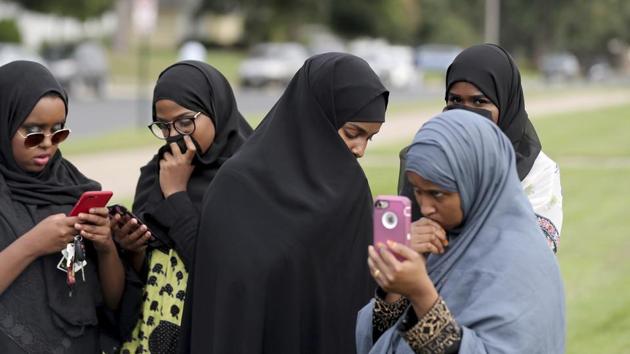 People make phone calls as law enforcement investigate an explosion at the Dar Al-Farooq Islamic Center in Bloomington on Saturday, August 5, 2017. (AP) People make phone calls as law enforcement investigate an explosion at the Dar Al-Farooq Islamic Center in Bloomington on Saturday, August 5, 2017. (AP)