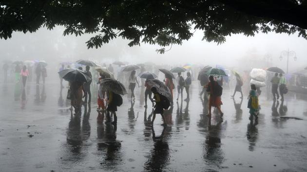 People walking with umbrellas on fog covered Ridge during rainfall, Shimla. (Deepak Sansta / HT Photo) People walking with umbrellas on fog covered Ridge during rainfall, Shimla. (Deepak Sansta / HT Photo)